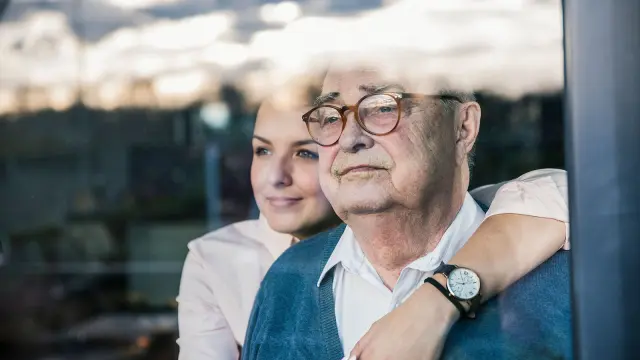 Frau legt Arm um älteren Mann