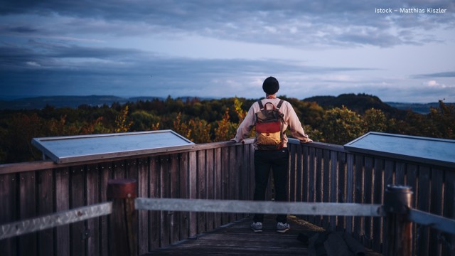 Mann steht alleine bei Aussichtspunkt