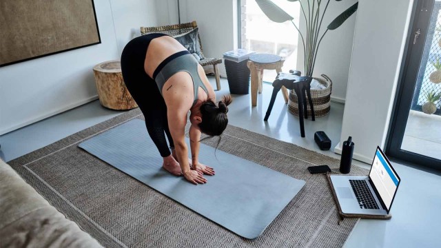 Frau macht Übungen auf Yogamatte